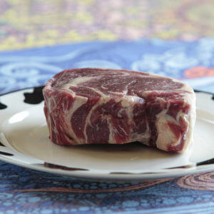 Grass-fed Delmonico steak on a white plate