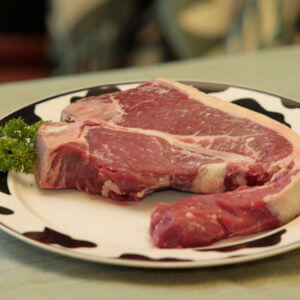 Grass-Fed Porterhouse steak on a white plate