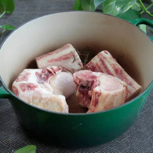 image of Beef Bones for Broth in a green bowl with broth