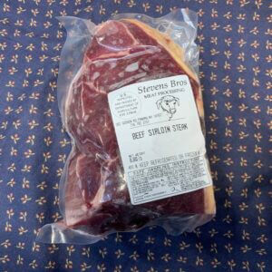 Image of a grass-fed sirloin steak in a package.