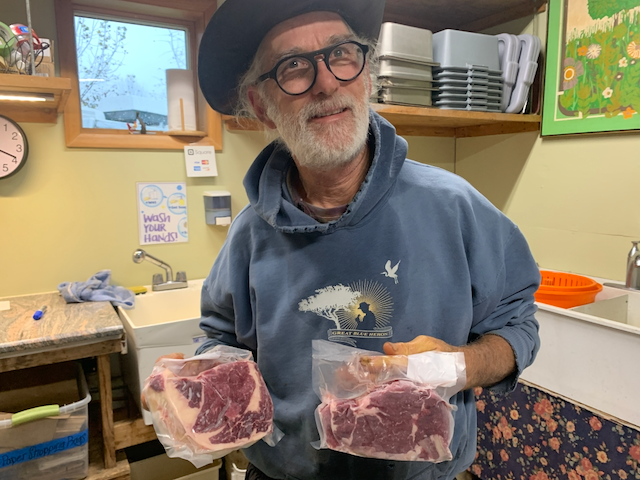 man with steaks in his hands